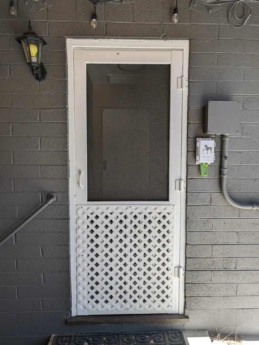 Screen door with a lattice kick panel on a back entry
