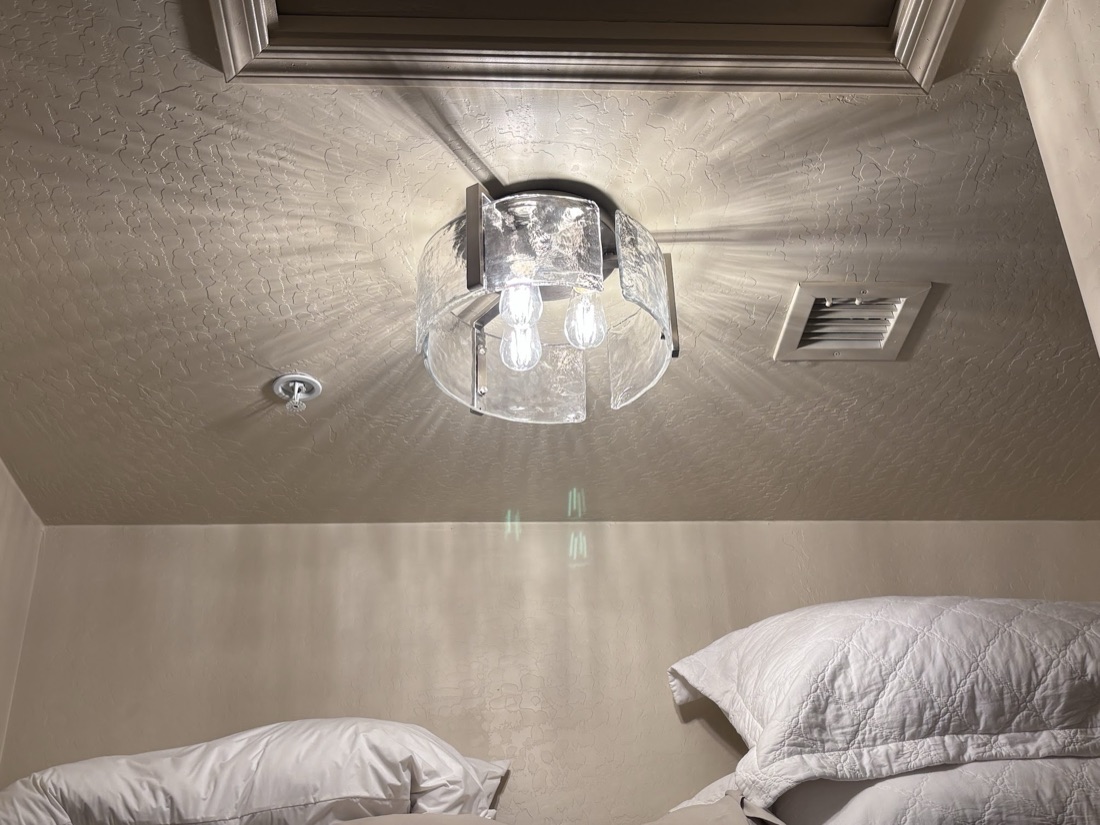 Glass flush-mount ceiling light installed in a bedroom