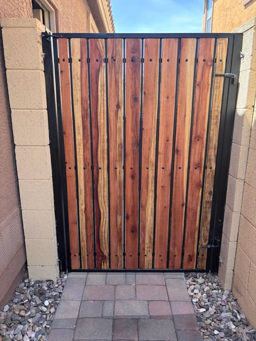 Side gate rebuilt with redwood slats on a black steel frame