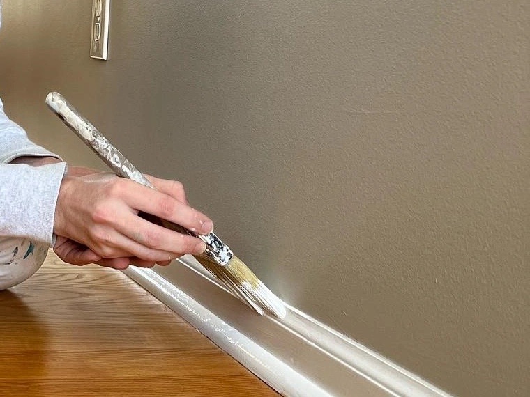 Cutting in a baseboard with a brush for a clean line