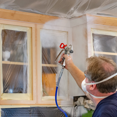 Spraying cabinets with glass doors and surroundings masked off