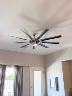 Brushed nickel 8-blade ceiling fan with LED light in a living room