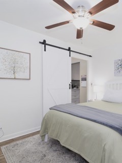White sliding barn door on black hardware in a bedroom