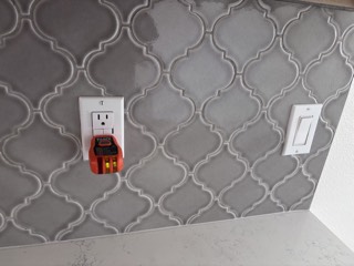 New GFCI outlet in a tile backsplash, tested for correct wiring
