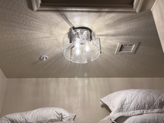 Glass flush-mount ceiling light installed in a bedroom