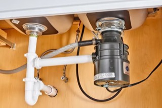 Garbage disposal installed under a double kitchen sink