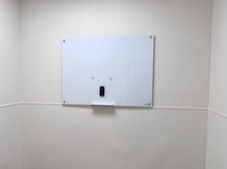 Frosted glass whiteboard mounted with standoff hardware