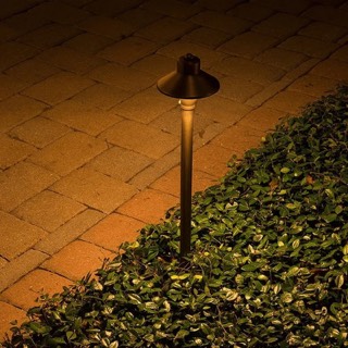 Brass path light along a paver walkway