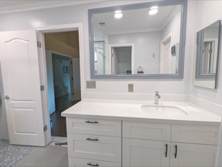 Large framed mirror centered over a bathroom vanity