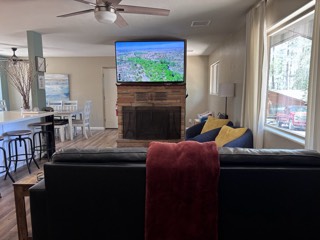 TV mounted above a stone fireplace in a mountain cabin